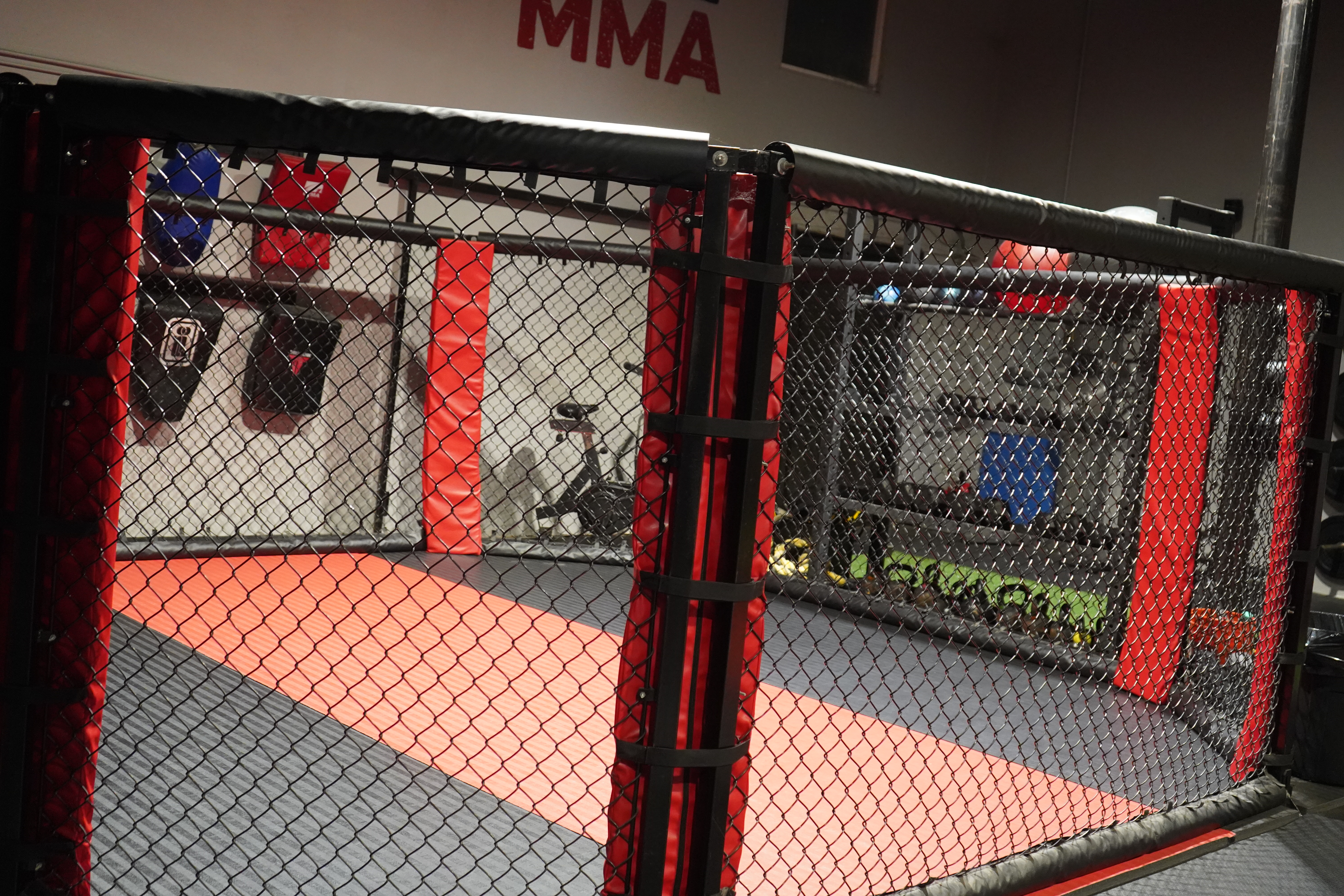 MMA cage interior — red and black