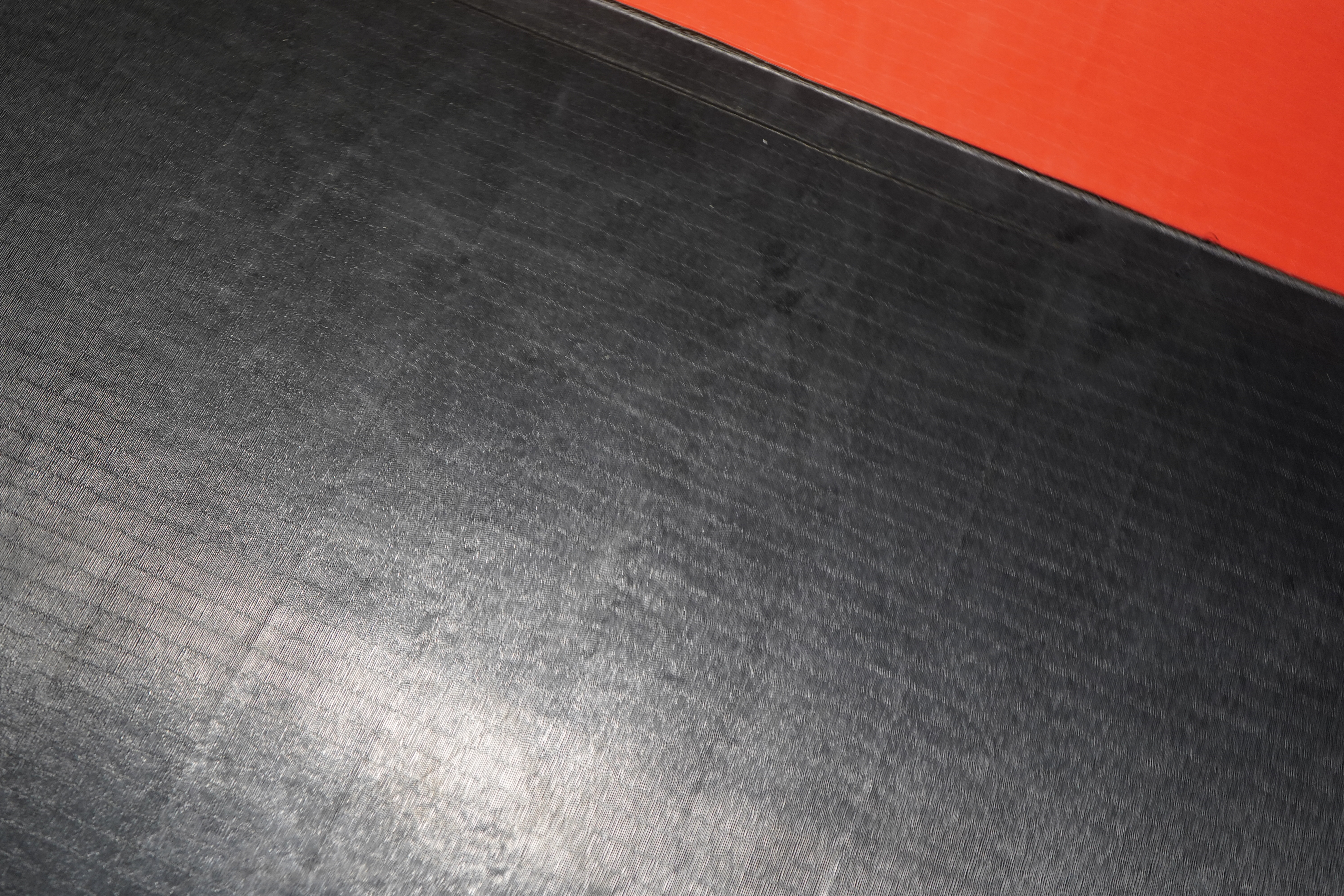 BJJ mat texture — black and red