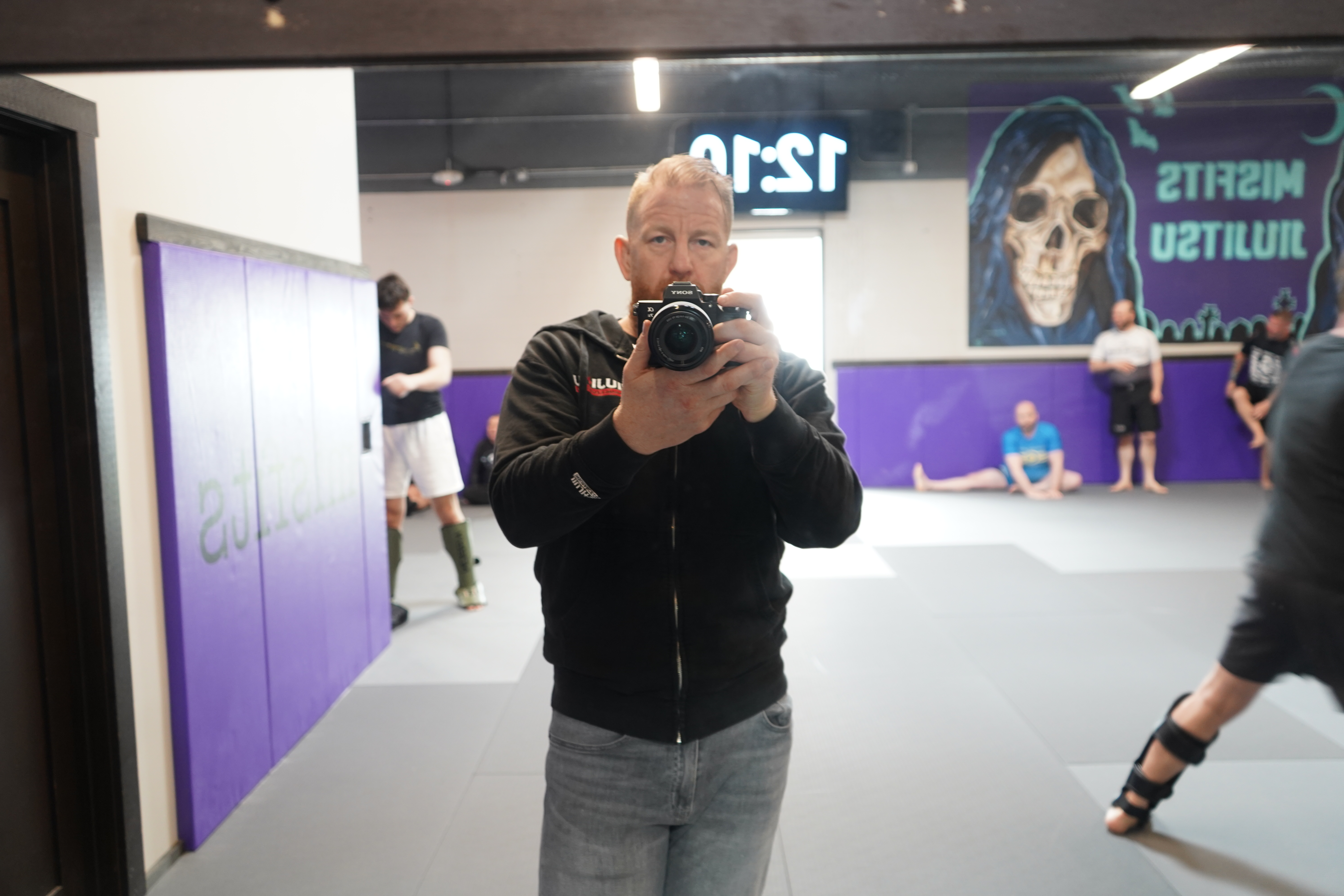 Chris Martin with Sony camera at Misfits Jiu Jitsu gym — on location production